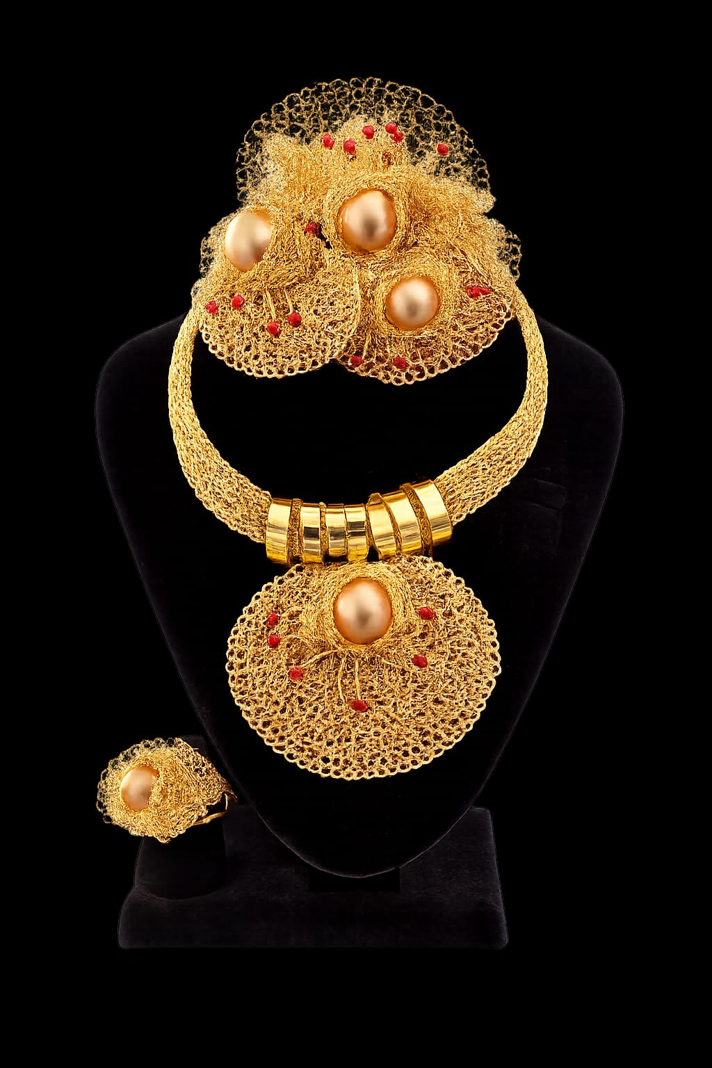 Gold woven mesh necklace with pearl centers and coral bead accents, matching ring