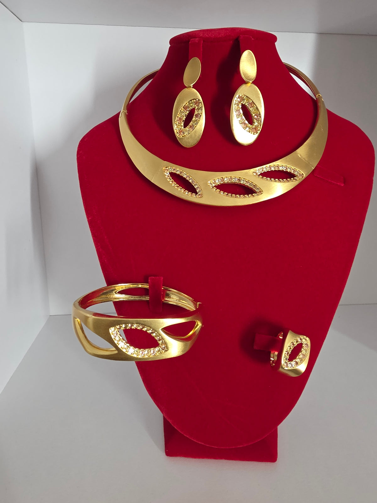 Gold collar necklace with crystal marquise cutouts, matching earrings, cuff and ring