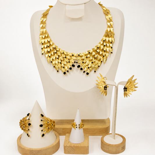 Gold feather bib necklace set with black crystal accents, earrings, bracelet and ring